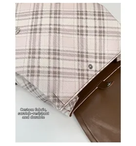 Detail of pink plaid fabric and brown leather with scratch-resistant custom material