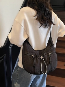 Large black pleated hobo crossbody bag with woven zip details and drawstring