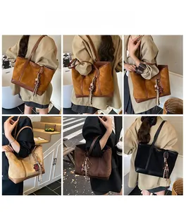 Close-up of suede patchwork tote bag with stylish tassel and polka dot bow detail