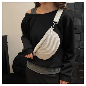 Detail of cream corduroy crossbody saddle bag with ethnic pattern wide woven strap