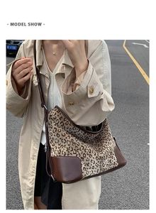 Detailed view of the leopard print tote bag with brown leather trim and reinforced base