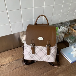 Detail of checkered backpack with pink plaid fabric and brown faux leather buckled flap