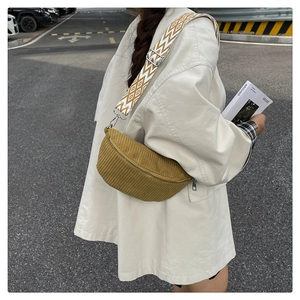 Detail of mustard yellow corduroy crossbody bag with geometric pattern wide strap