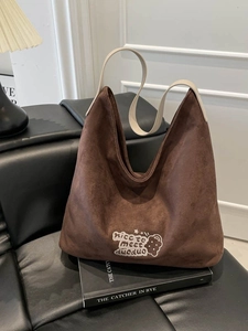 Large leopard print bucket bag with suede texture and embroidery detail