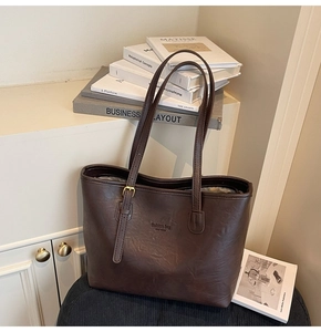 Detail of vintage brown leather tote bag showing fashion bag New York embossed text