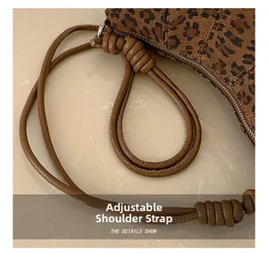 Detail view of the brown leopard print shoulder bag featuring an adjustable strap knot