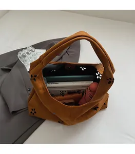 Macro view showing the large interior capacity of the suede floral cutout tote bag