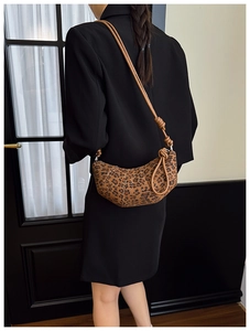 Leopard print crescent bag detail with fabric texture and adjustable knotted strap