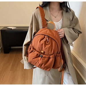 Caramel orange casual backpack with drawstring pocket and lightweight wrinkled nylon texture