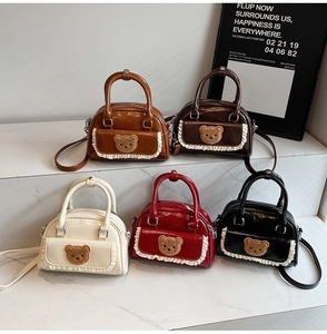 Detailed macro view showing five colors of mini Boston bags with cute bear lace pockets