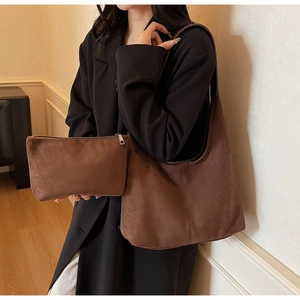 Close-up of brown suede hobo bag set including tote and matching zipper pouch