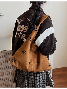 Brown suede tote bag with laser-cut floral patterns and comfortable wide shoulder strap