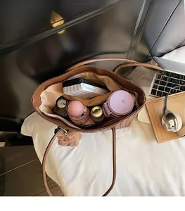 Interior view of brown woven tote bag showing large capacity for laptop and daily essentials