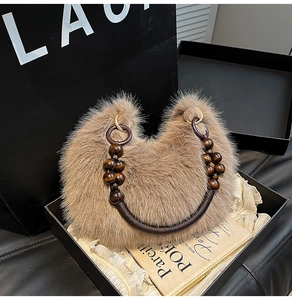 Détail du sac croissant en fausse fourrure marron avec anse en perles de bois