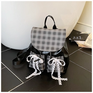 Detail of plaid拼接backpack featuring white lace bow knots and gray checked pattern