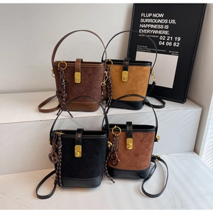 Close-up of four vintage quilted bucket bags in brown, khaki, and black suede textures