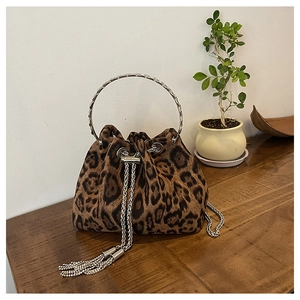 Detail of leopard print bucket bag with silver metal handle and chain tassels