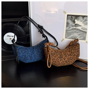 Detail of leopard print crossbody bags with chunky rope strap and textured fabric