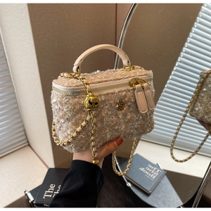 Detailed close-up of tweed chain crossbody bag with camellia logo and metal ball adjuster