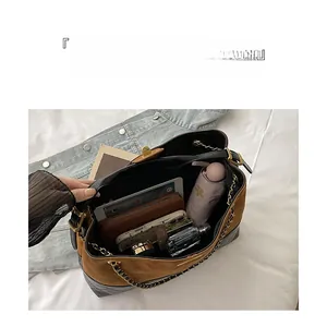 Interior view of large tote bag showing quilted leather and suede compartments