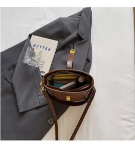 Top view of a brown bucket bag showing interior space for phone, wallet and cosmetics