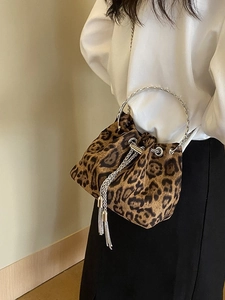 Fashionable leopard print bucket bag with metal ring handle and chain tassel detail