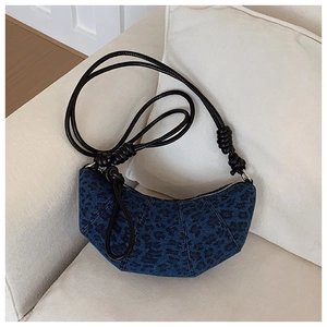 Detail of dark blue leopard print croissant bag with leather knotted shoulder strap