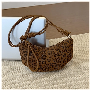 Detail of leopard print hobo bag with knotted brown cord strap and silver zipper