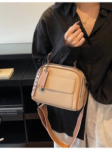Vintage beige litchi grain satchel bag with wide shoulder strap worn by model