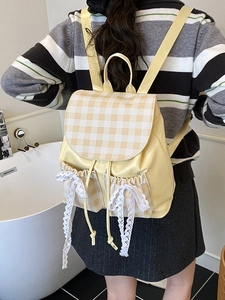 Chic yellow plaid backpack with lace bows and drawstring closure shown on model