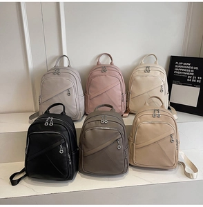 Collection of textured faux leather backpacks in multiple colors with ring zippers