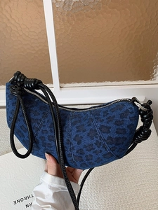 Blue denim leopard print crescent bag with black rope strap and silver zipper closure