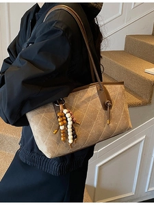 Vintage brown quilted tote bag with wooden bead tassel and long leather shoulder strap
