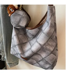 Detail view of denim-print tote bag set with matching round coin purse and leather trim