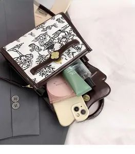 Interior view of small vintage crossbody bag showing space for phone and cosmetics