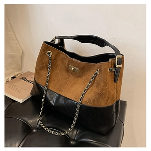 Detail of the vintage suede tote bag with quilted leather texture and golden metal twist lock