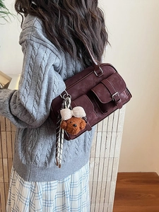 Vintage burgundy Boston shoulder bag in matte finish with a cute plush bear pendant