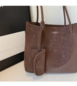 Close-up of vintage brown tote bag with marble texture and matching charm pouch