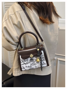 Detail of crossbody bag with Chinese landscape embroidery and gold clover twist lock