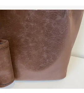 Detailed macro shot of vintage brown faux leather texture with printed fashion lettering