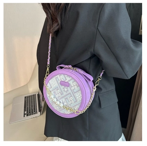 Detail of purple crossbody bag with floral embroidery and elegant pearl chain strap