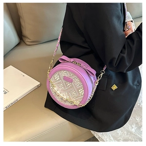 Detail of purple round crossbody bag with floral embroidery and pearl chain strap