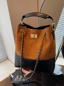 Vintage suede bucket bag with brown and black contrast colors and quilted texture