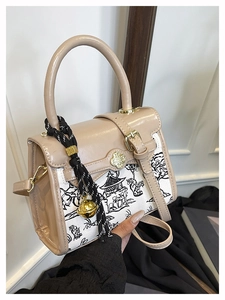 Detail of apricot mini handbag with landscape print and clover buckle clasp