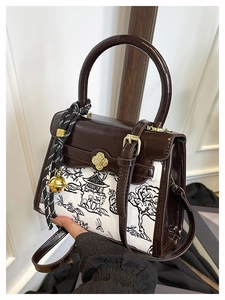 Detail of retro color-block bag with mountain pattern canvas and golden petal clasp