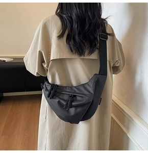Detailansicht einer schwarzen Nylon-Halbmondtasche mit gewebten Reißverschlussdetails