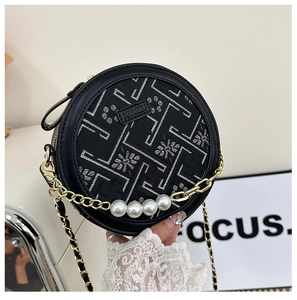 Detail of round Chinese style bag with pearl handle and geometric embroidery
