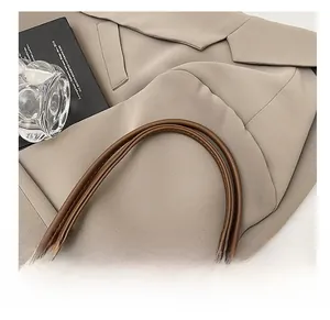 Close-up of comfortable deep brown leather straps on a minimalist tote bag for daily commute