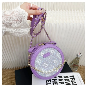 Detail of purple circular bag with floral embroidery, pearl chain, and golden hardware