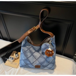 Blue denim texture tote bag with diamond stitching and adjustable leather shoulder strap